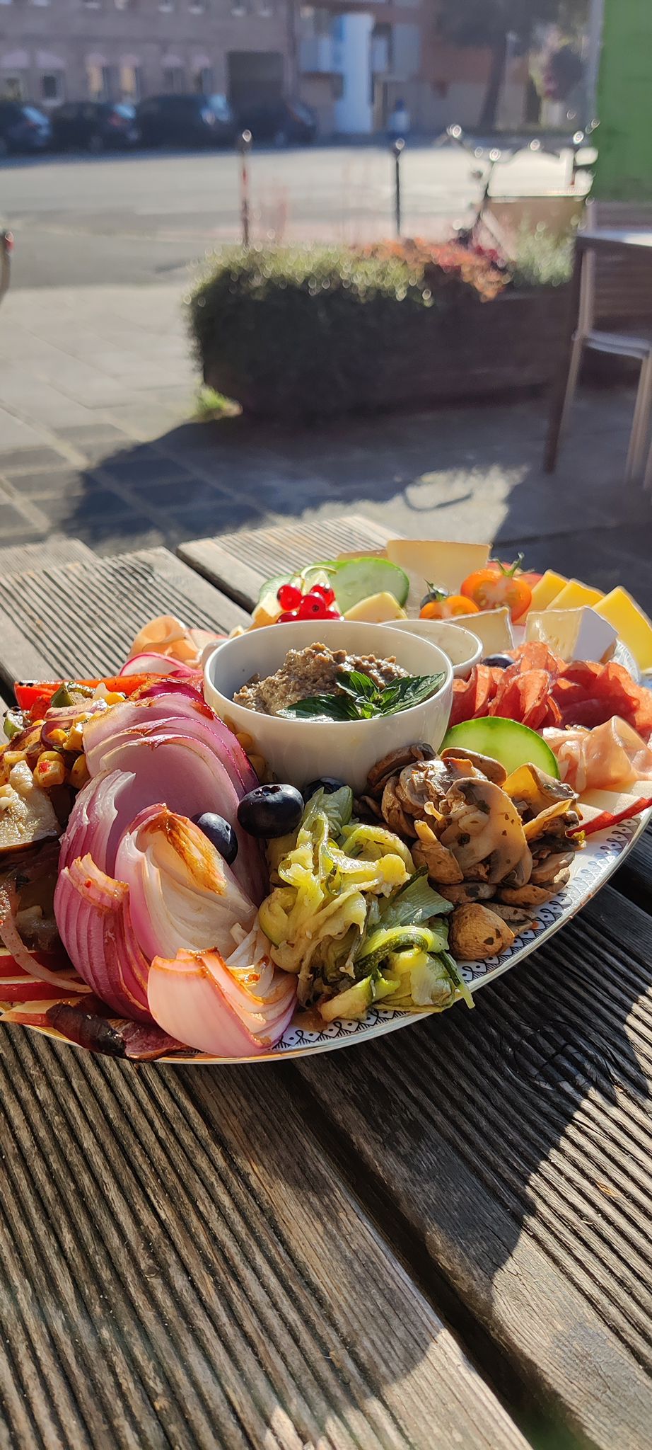 Charcuterie board with vegetables and a dip.