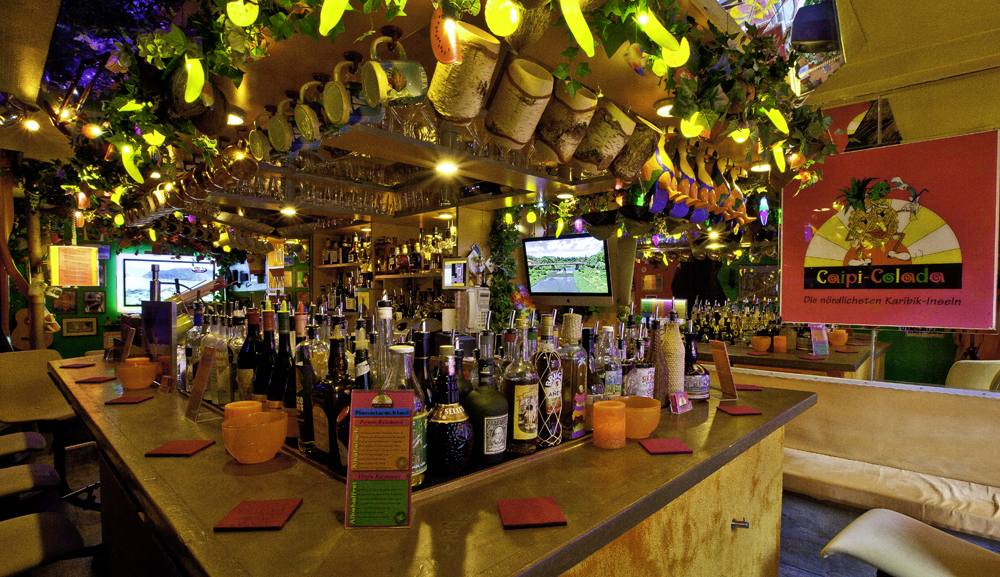 Colorful bar with bottles, vibrant decorations.