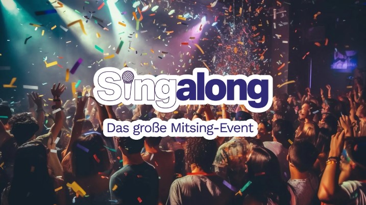 Crowd partying under colorful lights and confetti.