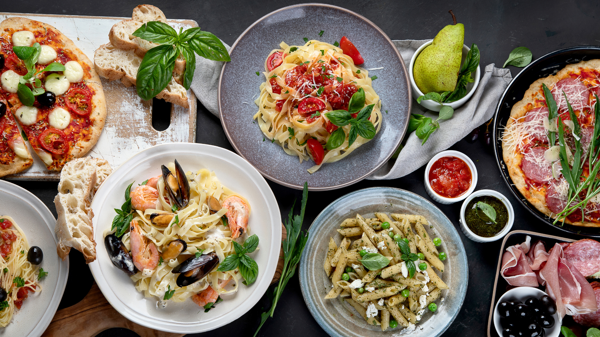Various Italian dishes beautifully arranged on table.