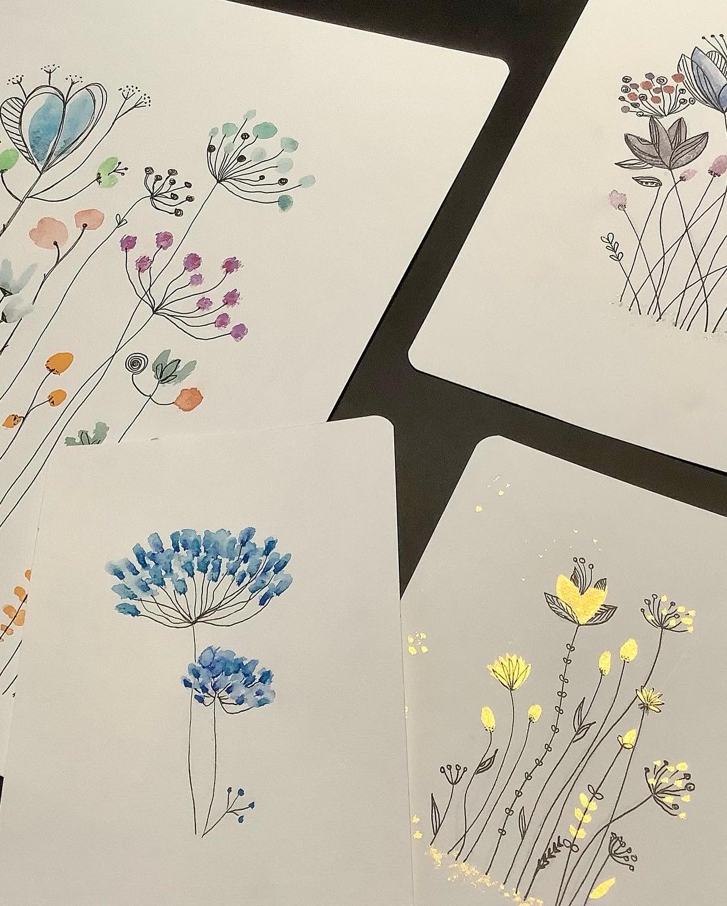 Hand-drawn floral designs on white cards.