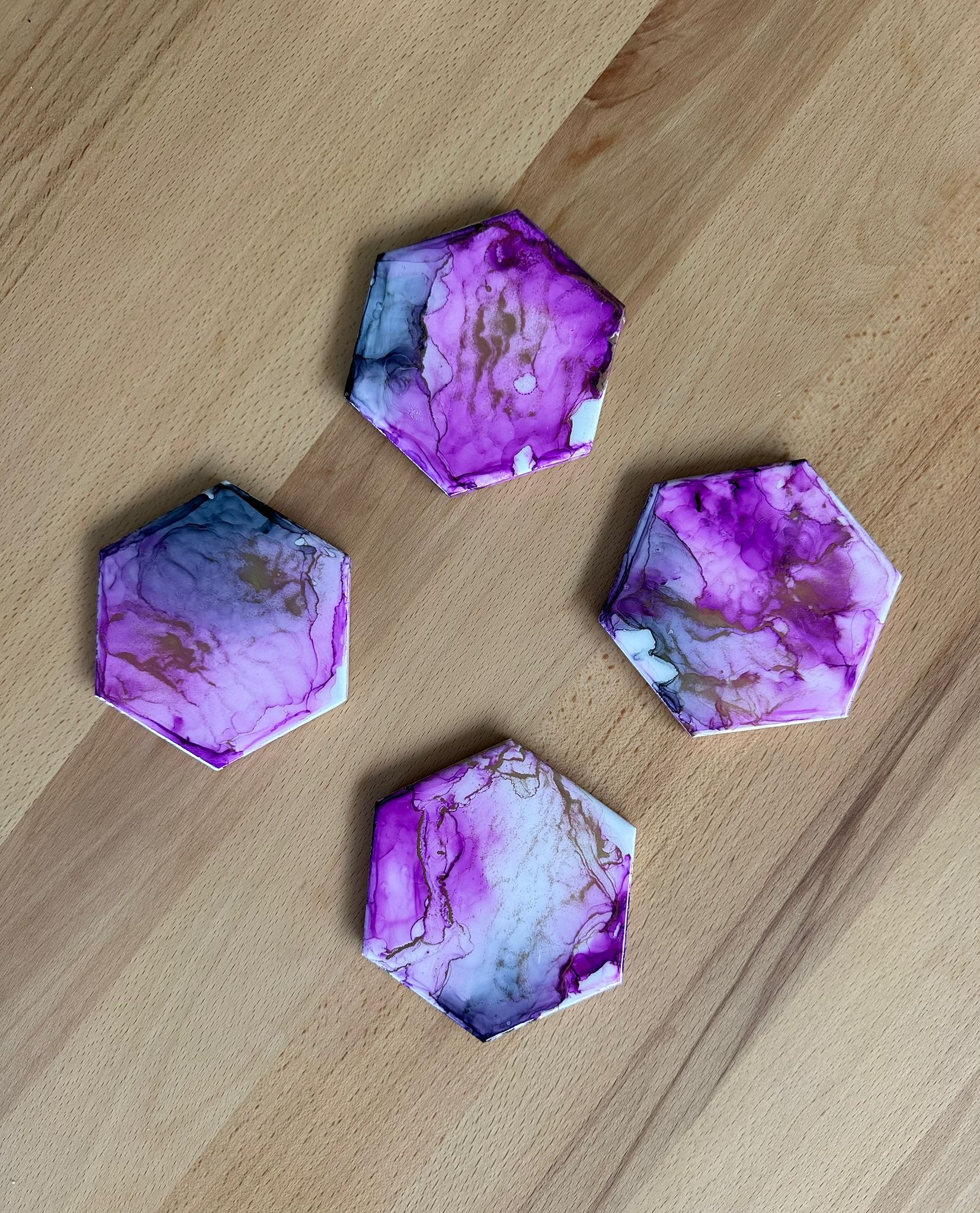 Hexagonal coasters with purple marble pattern.