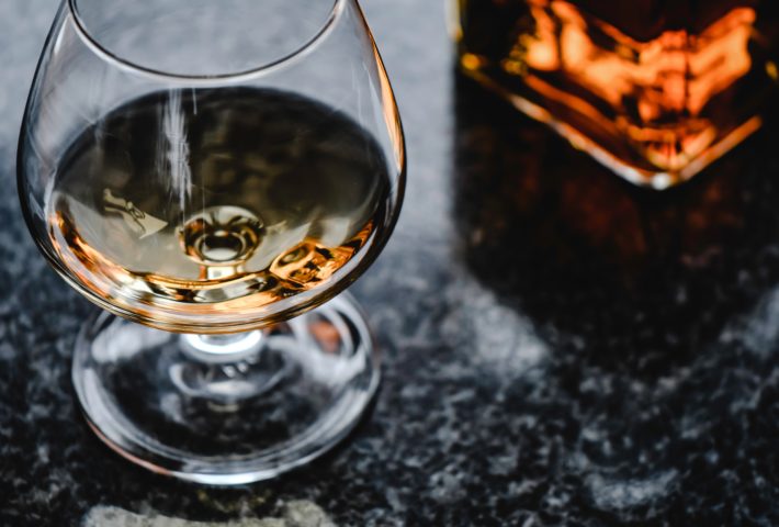 A glass with liquid stands on a surface.