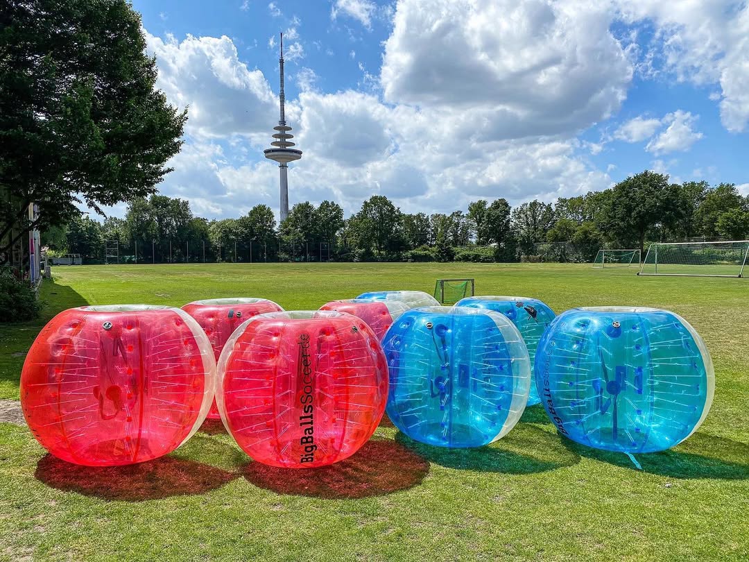 Inflatable balls on a grassy field.