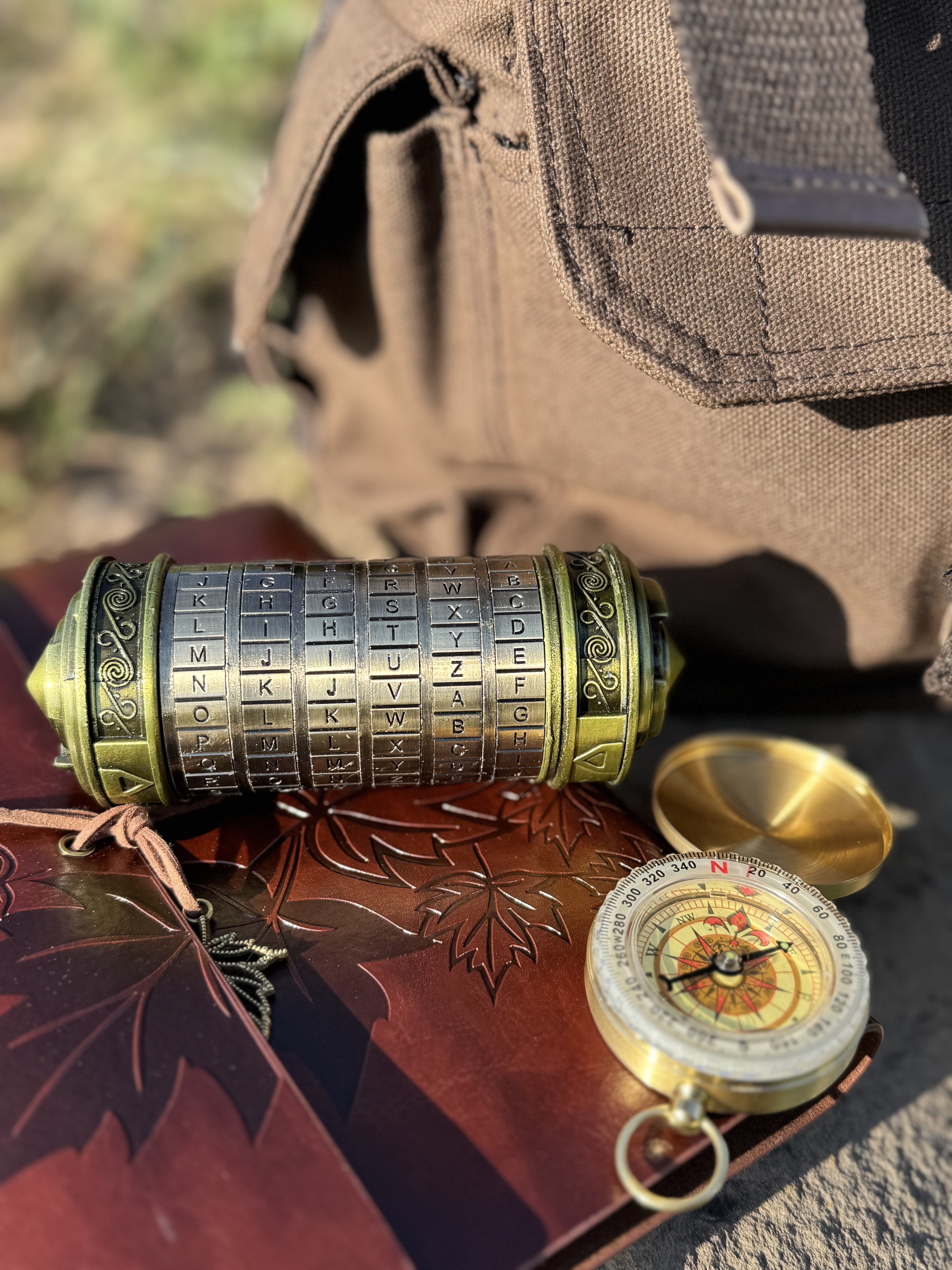 Cryptex and compass on a decorated surface.