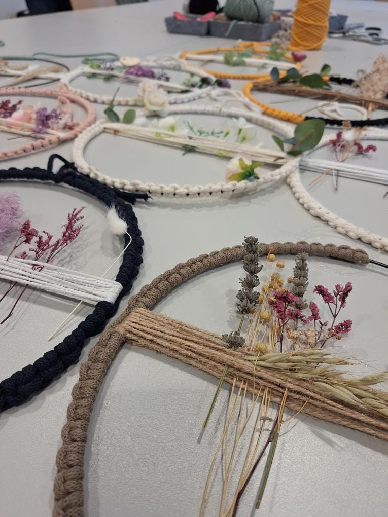 Macrame hoops with dried flowers and cords.