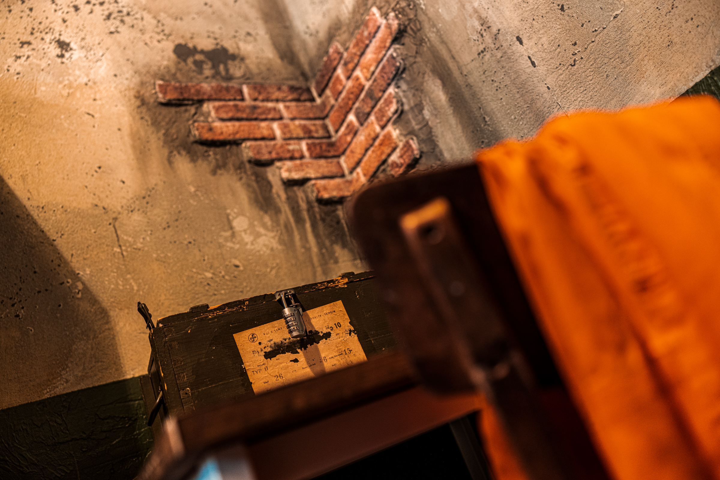 Brick wall with old trunk and orange cloth.