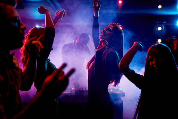 People dancing in a smoky nightclub