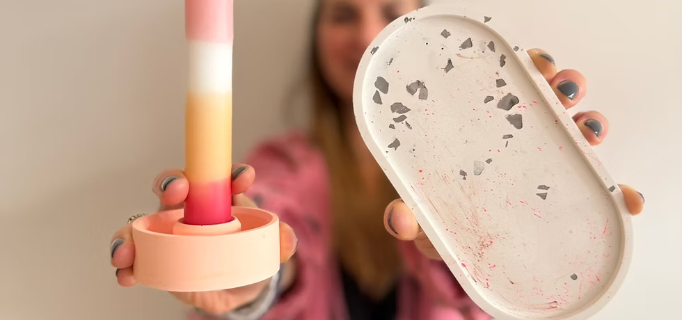Person holds colorful candle and decorative tray.