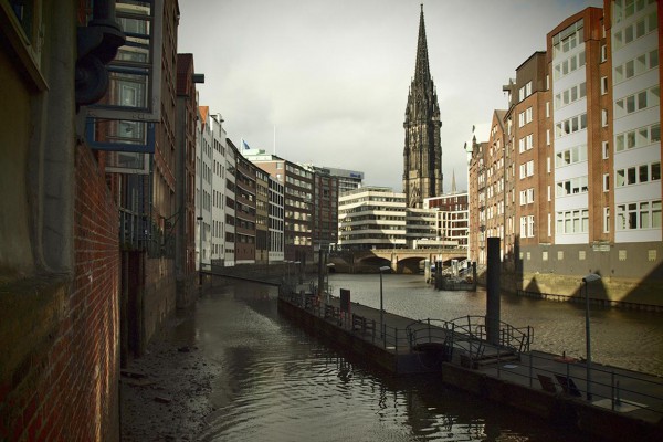 View of the old town with church, waterways and modern buildings.