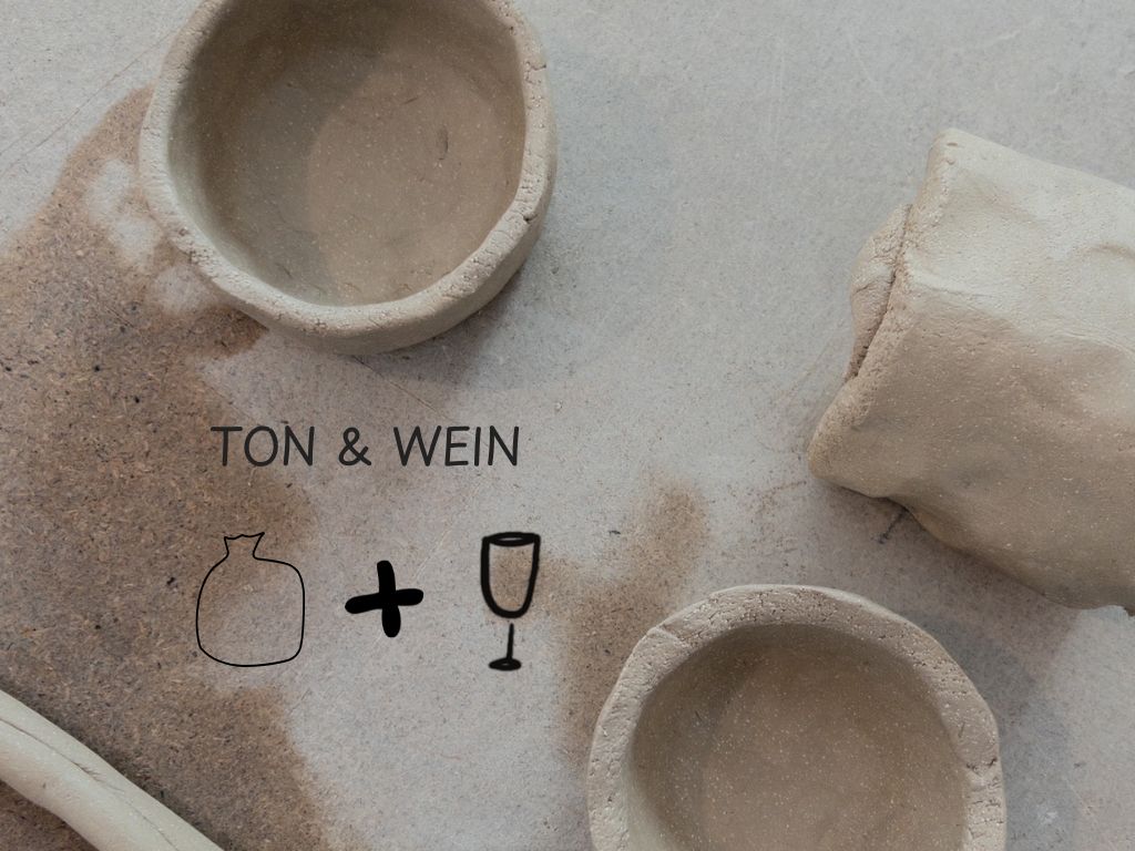 Clay bowls and text on sandy surface.